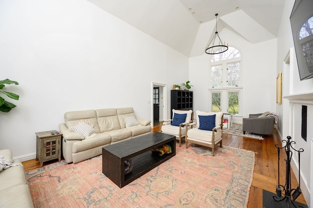 living room featuring wood-type flooring and high vaulted ceiling