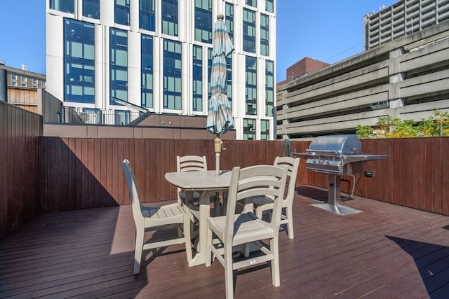 wooden terrace featuring a grill