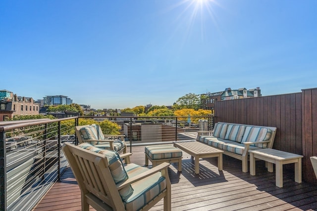 wooden terrace with an outdoor hangout area