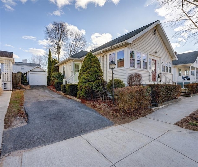 view of front of home with an outdoor structure and a garage