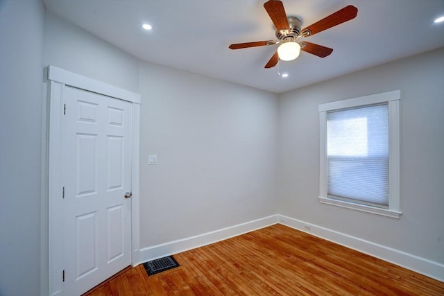 spare room featuring wood-type flooring and ceiling fan