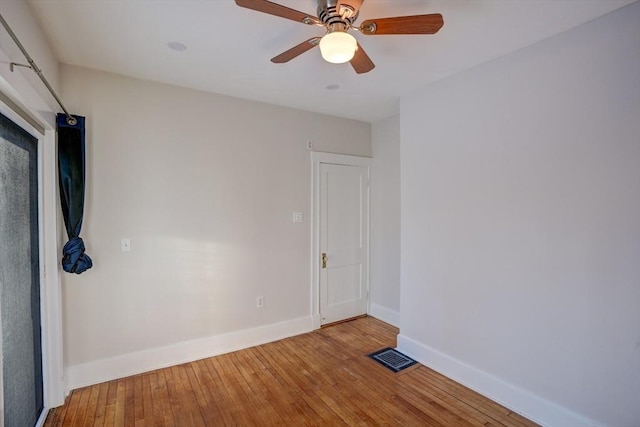 spare room featuring ceiling fan and hardwood / wood-style flooring