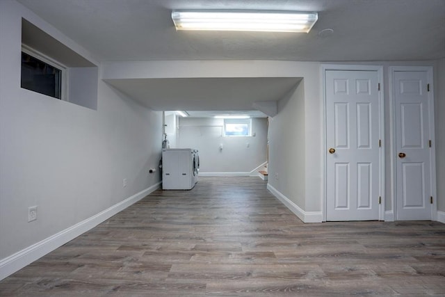 basement with hardwood / wood-style floors and washer / dryer