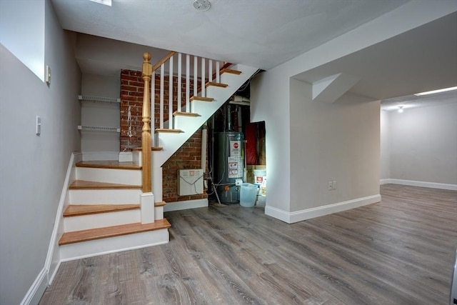 basement featuring hardwood / wood-style floors and gas water heater