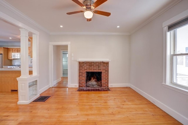 unfurnished living room with a brick fireplace, light hardwood / wood-style flooring, and ornamental molding