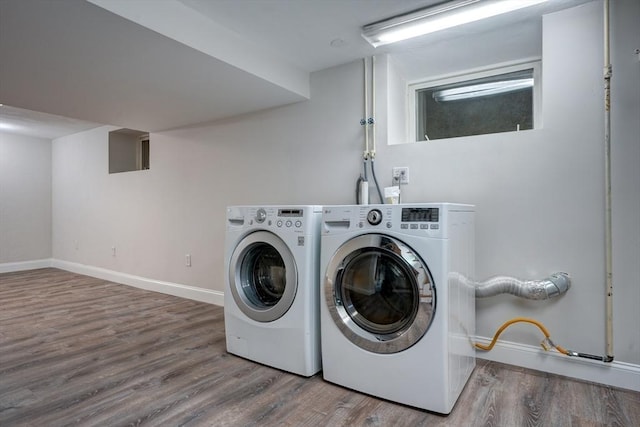 washroom with wood-type flooring and separate washer and dryer