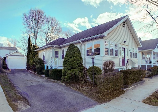 view of front of property with an outdoor structure and a garage