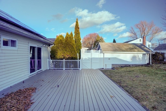 wooden terrace featuring a lawn