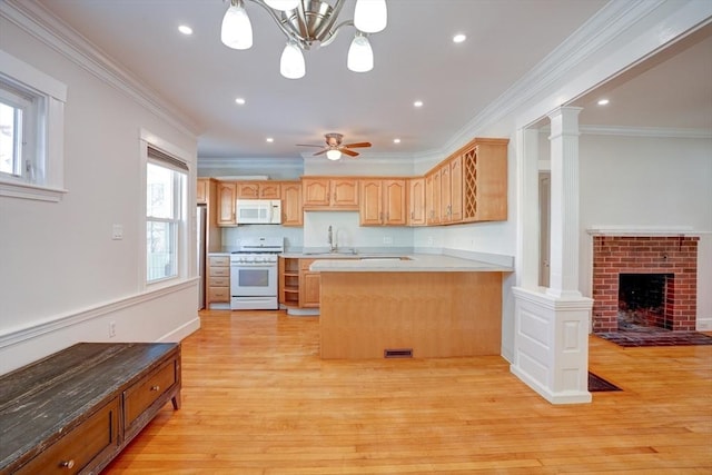 kitchen featuring light brown cabinets, crown molding, white appliances, and kitchen peninsula