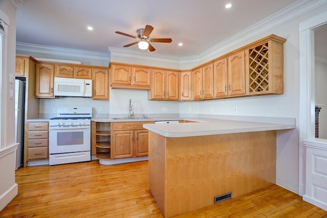 kitchen featuring kitchen peninsula, white appliances, sink, and ornamental molding