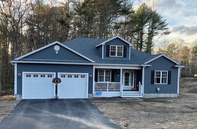 view of front facade with a garage and a porch