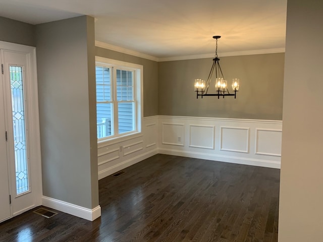 entrance foyer with ornamental molding, a chandelier, dark hardwood / wood-style flooring, and a wealth of natural light