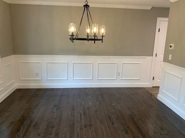 unfurnished dining area featuring ornamental molding, a chandelier, and dark hardwood / wood-style flooring