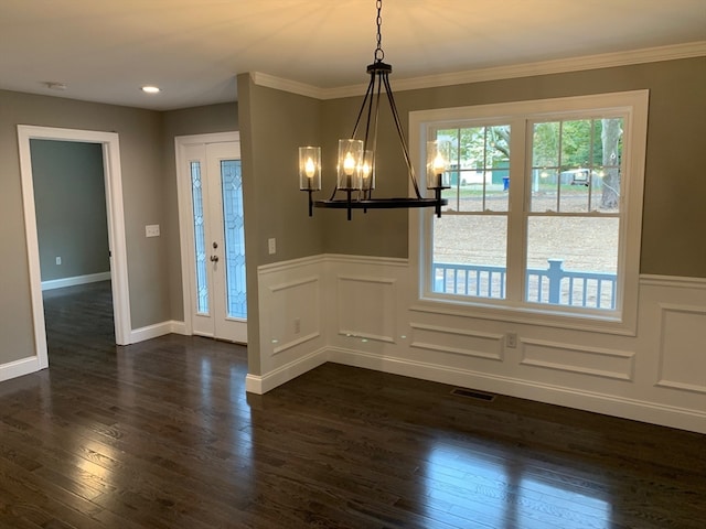 unfurnished dining area featuring crown molding, a chandelier, and dark hardwood / wood-style floors