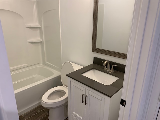 full bathroom featuring shower / bathing tub combination, vanity, hardwood / wood-style floors, and toilet