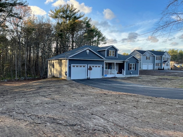 view of front of home featuring a garage and a porch