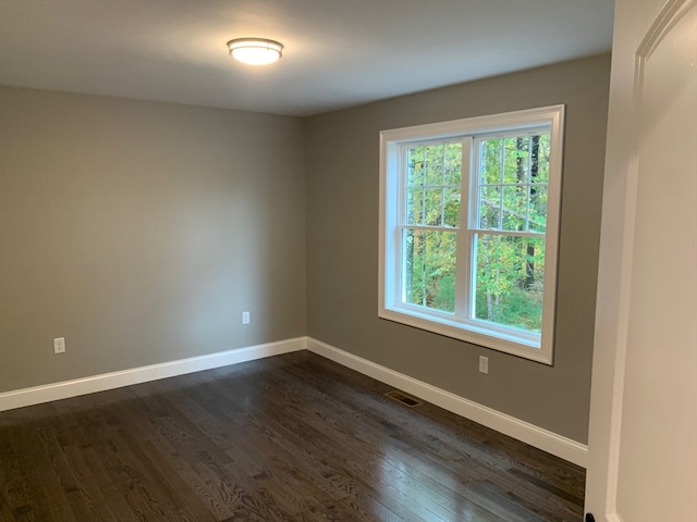 spare room with dark hardwood / wood-style floors