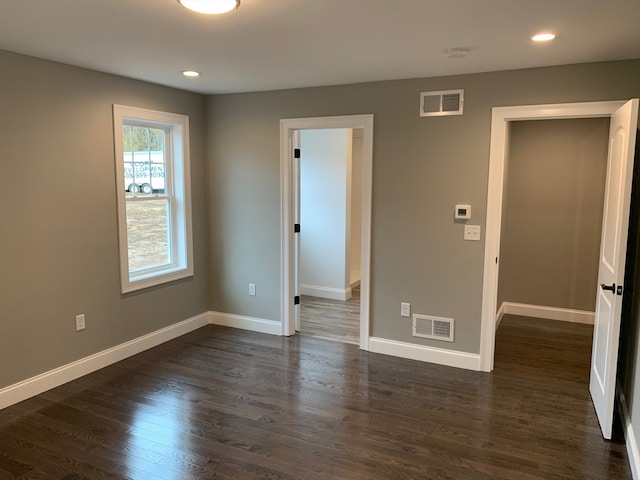 spare room featuring dark hardwood / wood-style flooring