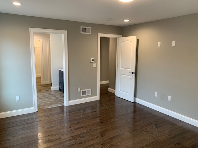 unfurnished bedroom with dark wood-type flooring