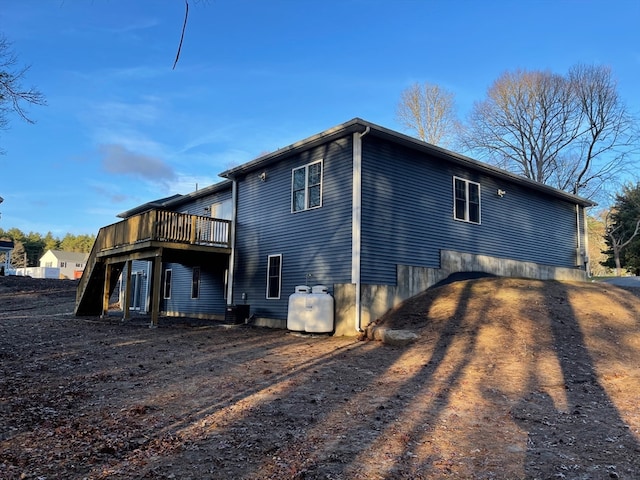 view of side of property with central air condition unit