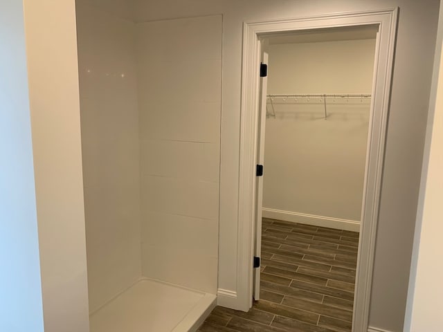 bathroom featuring wood-type flooring and a shower