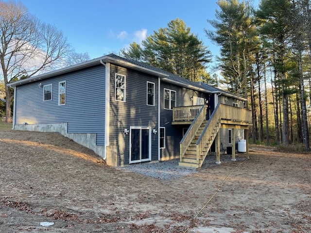 rear view of house with a wooden deck