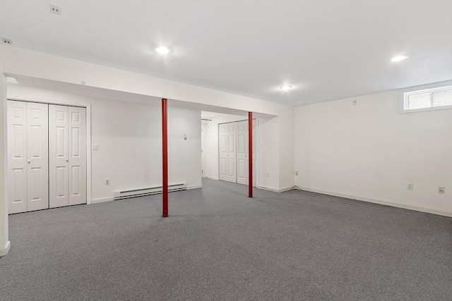 basement featuring carpet, a baseboard radiator, baseboards, and recessed lighting