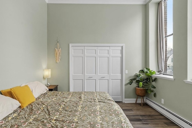 bedroom featuring dark wood-type flooring, multiple windows, a baseboard radiator, and crown molding