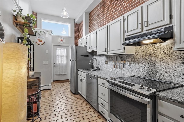 kitchen with under cabinet range hood, a sink, appliances with stainless steel finishes, baseboard heating, and backsplash