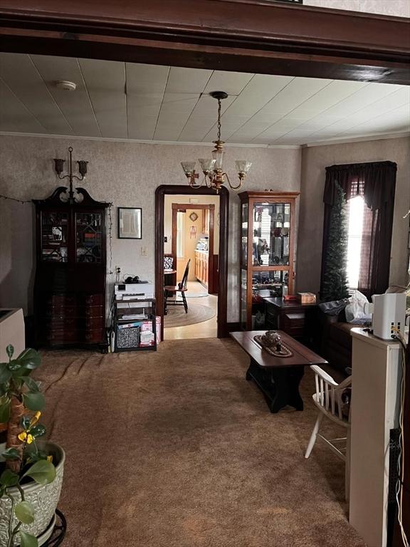 302 Cory St, Fall River, MA 02720 - carpeted living area with a chandelier