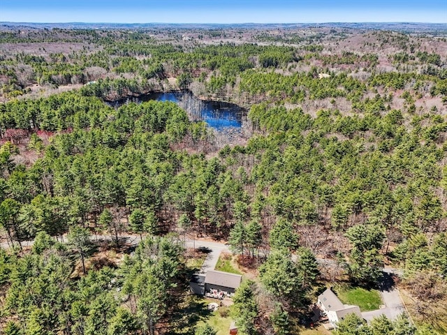 birds eye view of property with a water view and a forest view