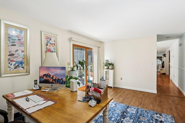 office area with baseboards and wood finished floors