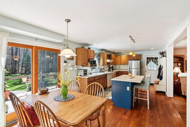 dining area featuring dark wood-style flooring, recessed lighting, plenty of natural light, and a toaster