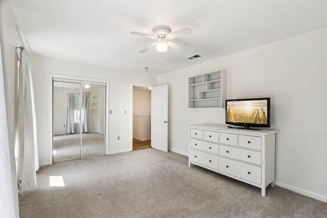 unfurnished bedroom featuring baseboards, ceiling fan, light carpet, and visible vents