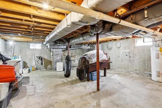 basement featuring plenty of natural light and water heater