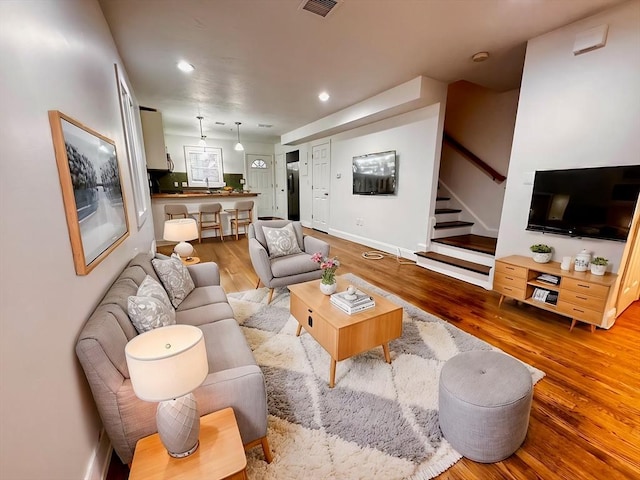 122 W 7th St Unit B, Boston, MA 02127 - living room featuring wood finished floors, stairway, and recessed lighting