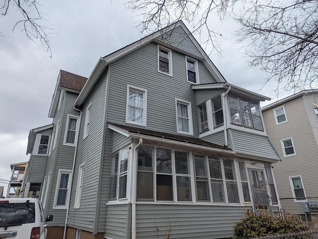 rear view of house featuring a sunroom