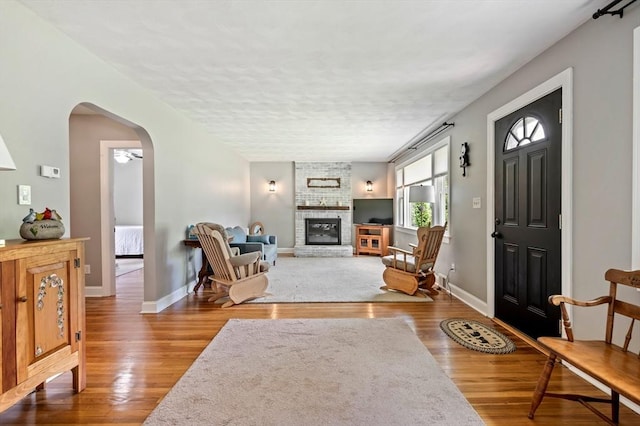 107 Washington St, Pembroke, MA 02359 - entryway with wood finished floors, a fireplace, arched walkways, and a textured ceiling