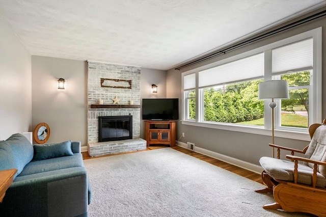 107 Washington St, Pembroke, MA 02359 - living room featuring a fireplace and wood finished floors