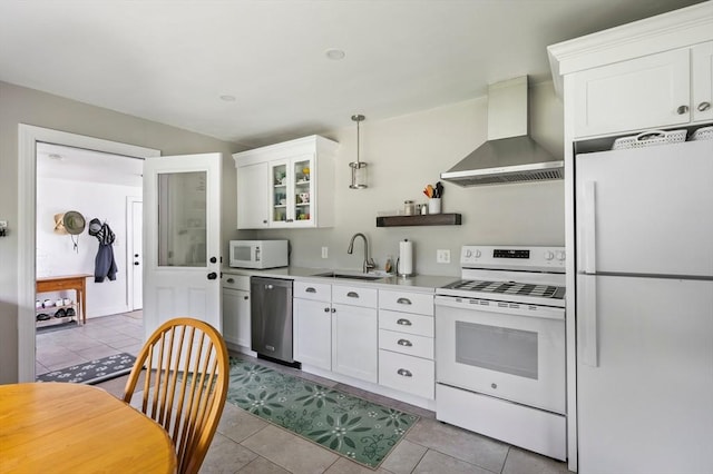 107 Washington St, Pembroke, MA 02359 - kitchen featuring white appliances, wall chimney range hood, light tile patterned floors, and white cabinets