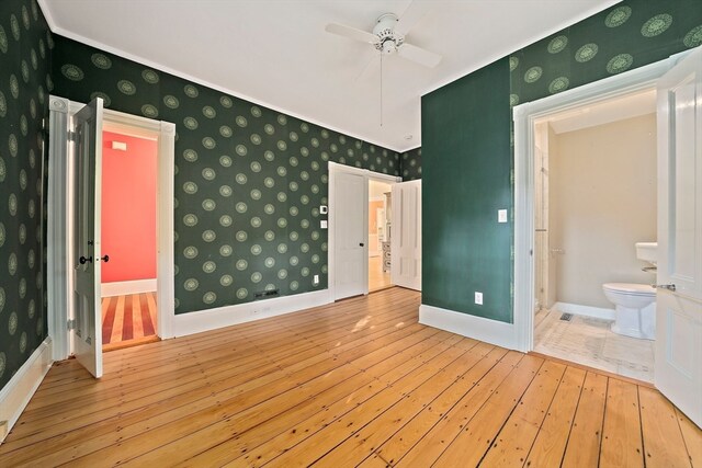 empty room with light wood-type flooring and ceiling fan