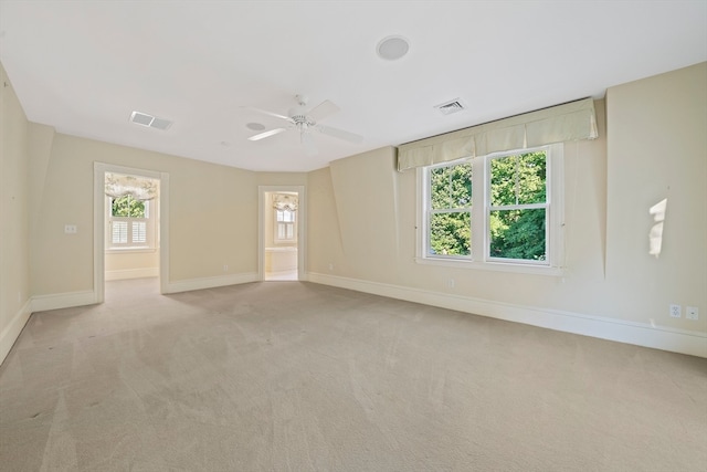 carpeted empty room featuring ceiling fan