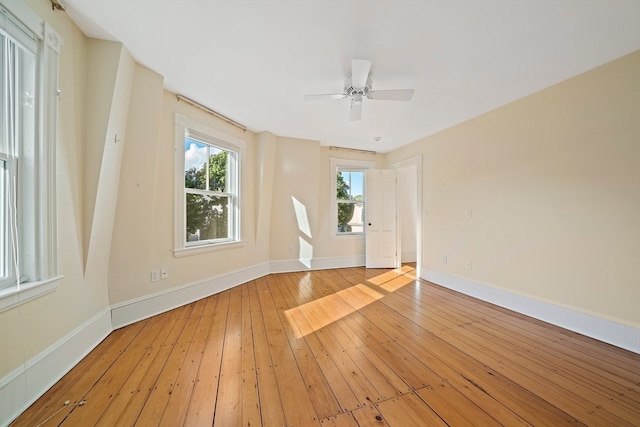 unfurnished room with ceiling fan and light hardwood / wood-style floors