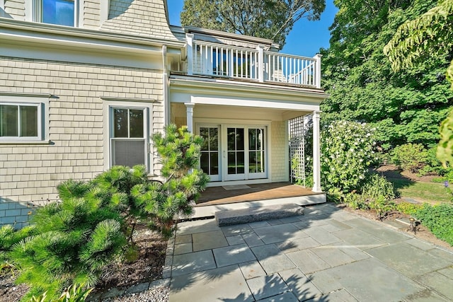 doorway to property featuring a balcony and french doors