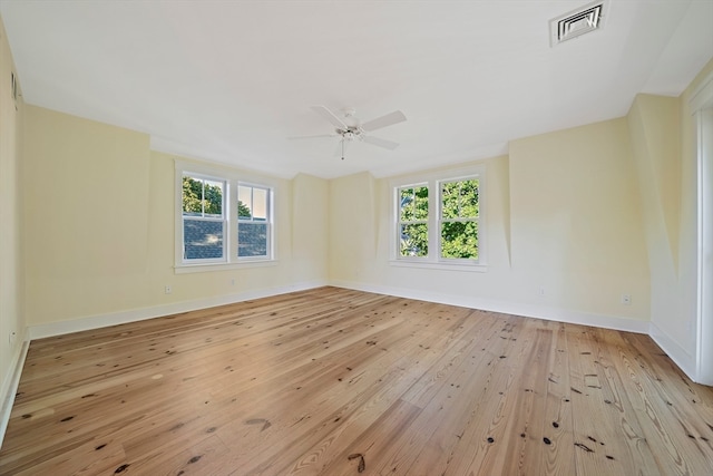 unfurnished room featuring light wood-type flooring, ceiling fan, and a wealth of natural light