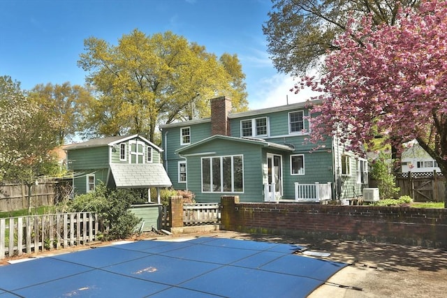 3 Norman Ave, Newburyport, MA 01950 - rear view of property featuring a chimney, fence, central AC, and a patio