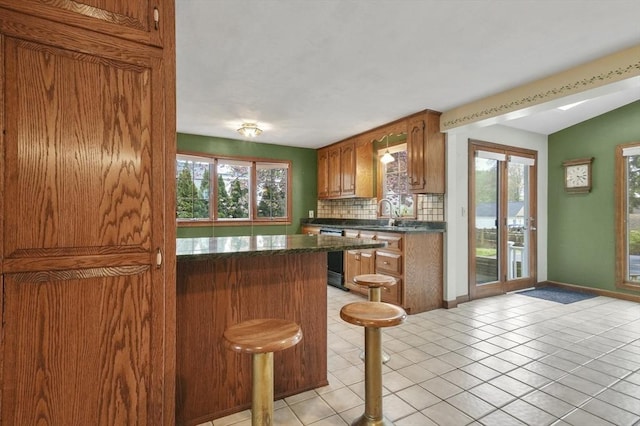 3 Norman Ave, Newburyport, MA 01950 - kitchen with backsplash, plenty of natural light, dishwasher, and light tile patterned flooring