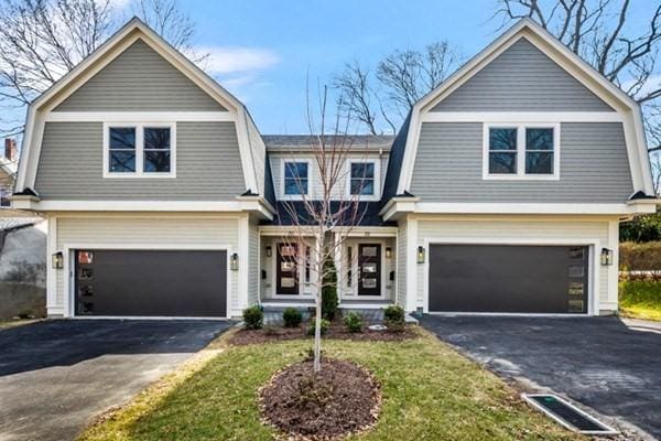 view of front of property featuring a garage and a front yard