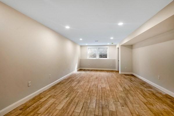 basement with light hardwood / wood-style flooring