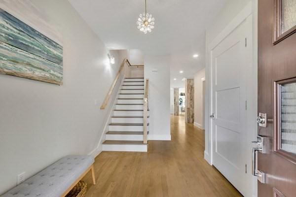 foyer with an inviting chandelier and light wood-type flooring